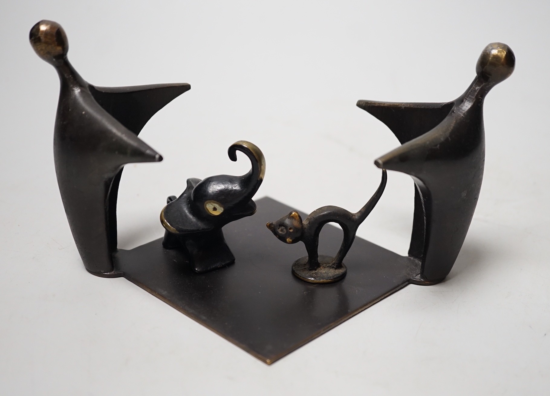 An abstract bronze group, 19cm wide, together with two other figures