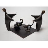 An abstract bronze group, 19cm wide, together with two other figures