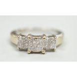 A modern 18ct white gold and triple princess cut diamond cluster set dress ring, size K, gross