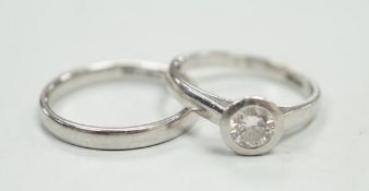 A modern platinum and collet set solitaire diamond ring, size M, gross weight 4.9 grams, together