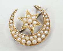 An Edwardian yellow metal and seed pearl set crescent moon and star brooch, 22mm, gross weight 4