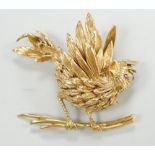 A 1960's Boucheron of Paris 18ct gold and ruby set brooch, modelled as a bird upon a branch, signed,