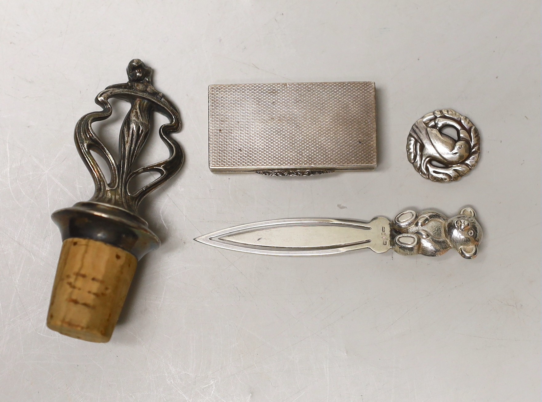 An Art Nouveau metal mounted cork stopper, a Georg Jensen sterling brooch, no. 191, an engine turned