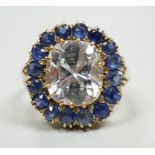 An early 20th century yellow metal and single stone cushion cut white sapphire set dress ring,