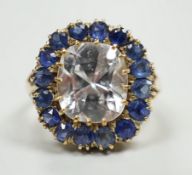 An early 20th century yellow metal and single stone cushion cut white sapphire set dress ring,
