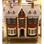 A mid 20th century doll's house and contents, 84cms x 100cms high
