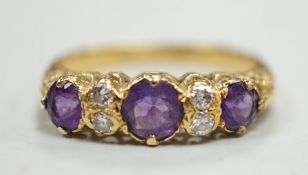 An 18ct, three stone amethyst and four stone diamond set half hoop ring, size Q/R, gross weight 4