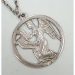 A late 1970's John Skelton silver pendant, depicting an angel with harp, diameter 63mm, on a