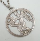 A late 1970's John Skelton silver pendant, depicting an angel with harp, diameter 63mm, on a