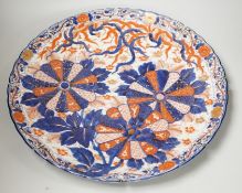 An Imari petal rimmed charger, in typical palette, Meiji period. 47cm