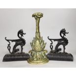 A pair of cast iron seated lion dog doorstops, together with A brass pineapple shaped door porter.