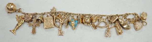 A 9ct charm bracelet, hung with assorted mainly 9ct gold charms, gross weight 46.1 grams.