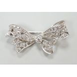 A white metal and diamond cluster set ribbon bow brooch, 36mm, gross weight 4 grams.