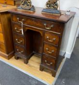 A George III style mahogany kneehole desk, width 73cm, depth 50cm, height 77cm