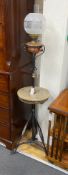 An Edwardian wrought iron and copper telescopic standard lamp with alabaster tier