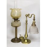 An Edwardian brass desk lamp with glass shade and a Victorian brass columned oil lamp with shade,