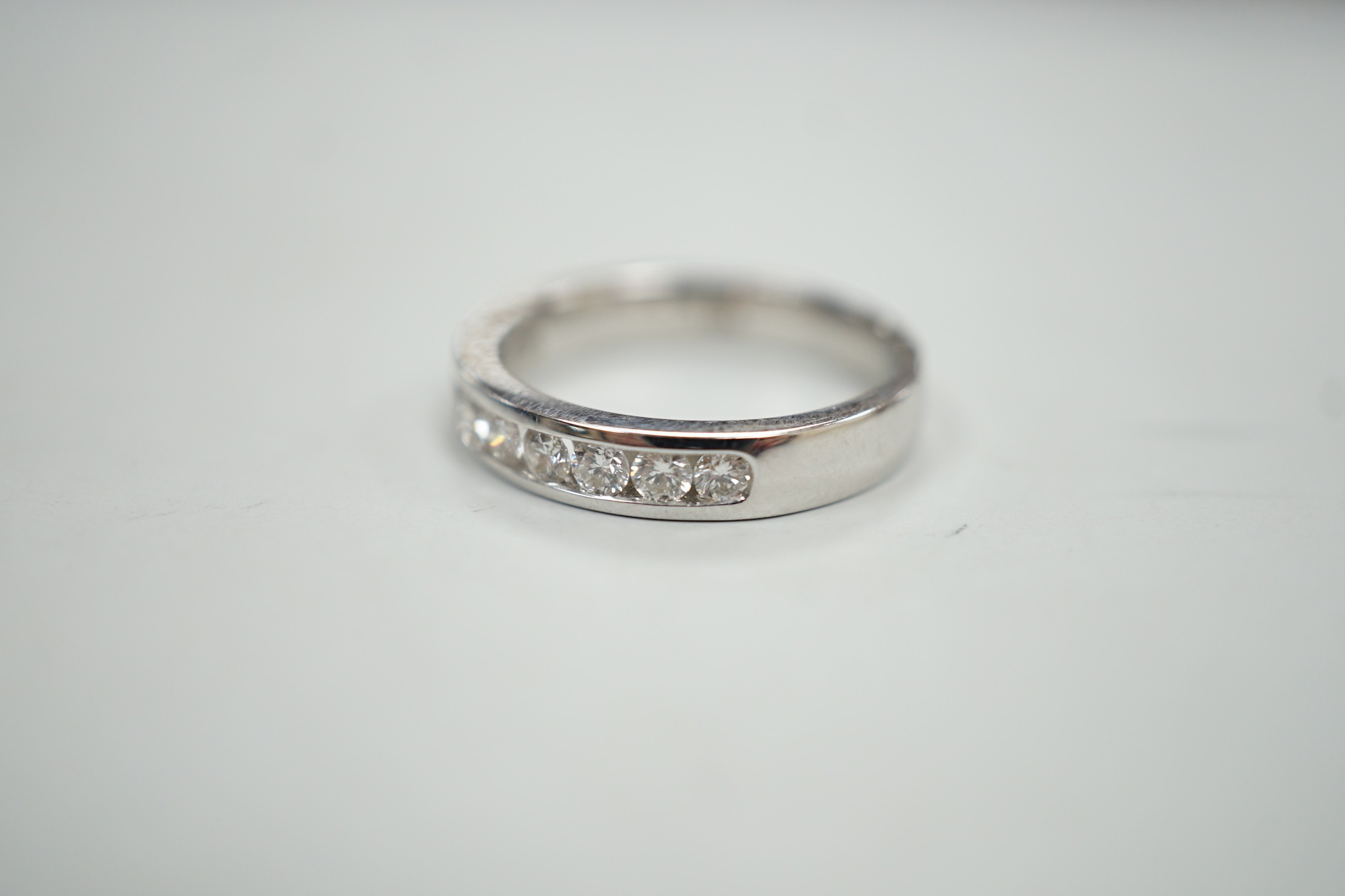 A modern 18k white metal and ten stone channel set diamond half eternity ring, size L/M, gross - Image 3 of 5