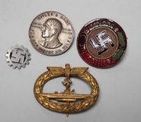 Four German WWII badges including a Kriegsmarine submarine war badge, maker’s mark Frank and Reif