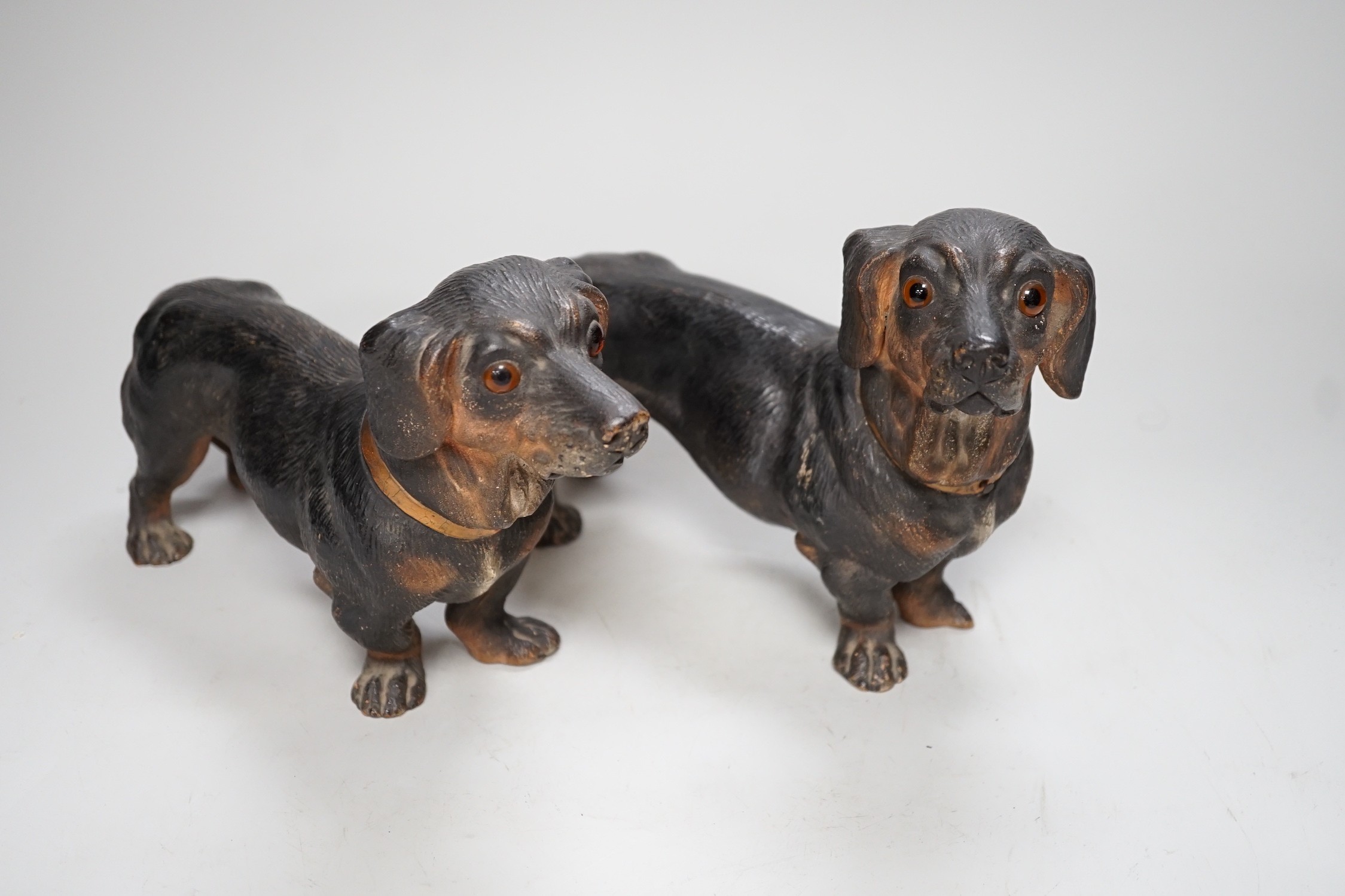 A pair of Austrian cold painted terracotta models of Dachshunds, one paw damaged, inset glass eyes - Image 2 of 5