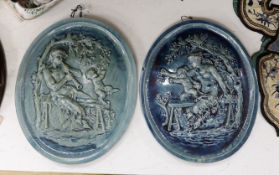 A pair of 19th century French turquoise glazed pottery wall plaques. 38cm tall