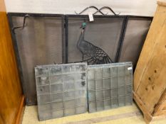 A set of six copper framed glass panels and a folding wrought iron peacock mesh folding fire