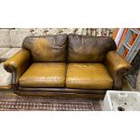 A Thomas Lloyd tan leather two seater sofa, length 190cm, depth 95cm, height 86cm