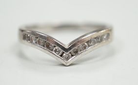 A modern 18ct white gold and channel set diamond chip wishbone shaped ring, size M, gross 3.4