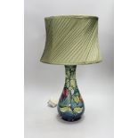 A 20th century Moorcroft lamp, stamped and with a Moorcroft label on the base, 35cms high (not