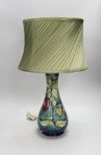 A 20th century Moorcroft lamp, stamped and with a Moorcroft label on the base, 35cms high (not