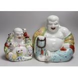 Two Chinese porcelain enamelled Budai figures, tallest 29cms high