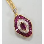 A modern 18k yellow metal, ruby and diamond cluster set quatrefoil shaped pendant, overall 25mm,