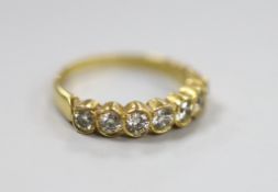 A modern 750 yellow metal and seven stone diamond set half hoop ring, size O, gross weight 3.2
