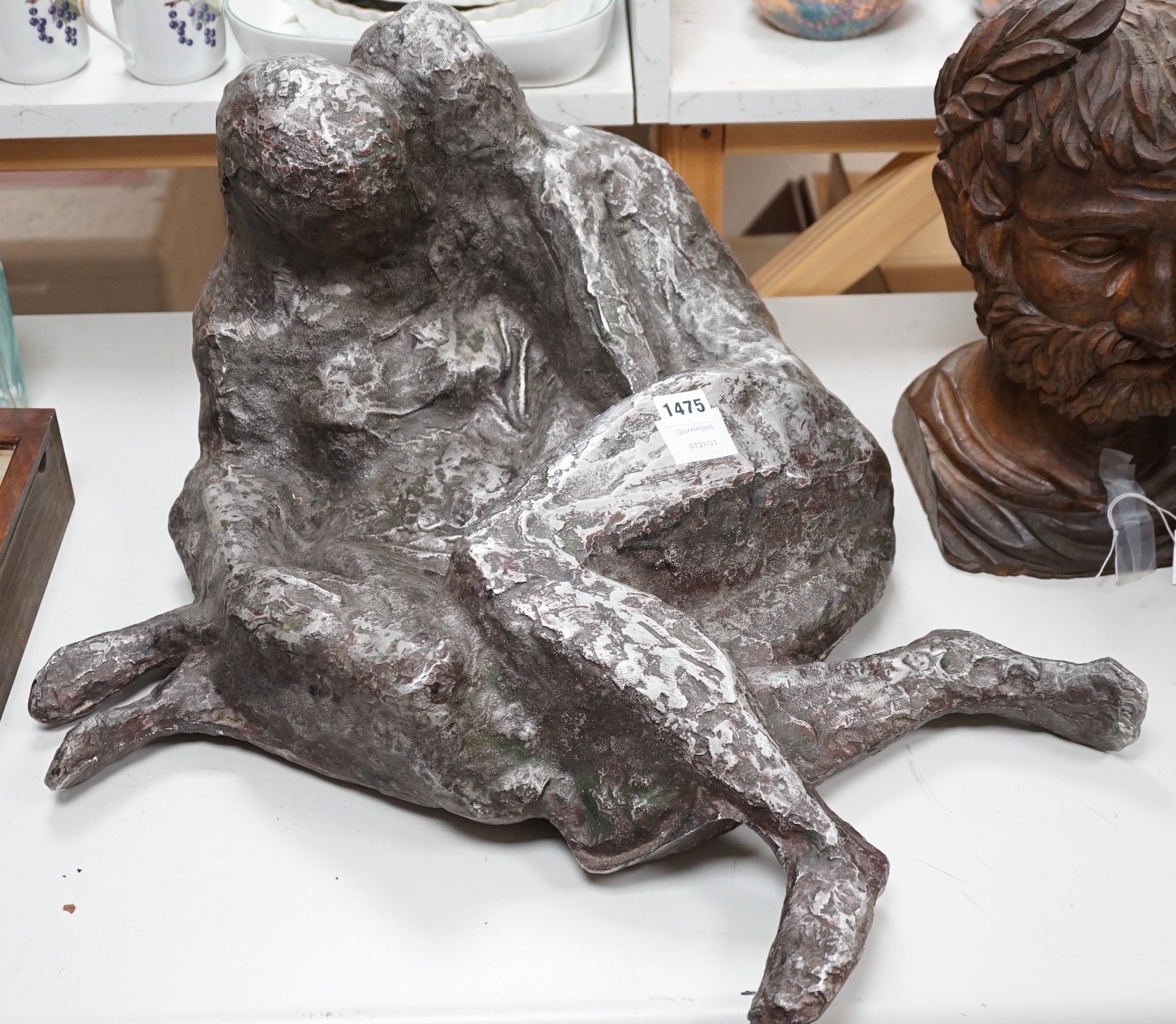 A large heavy cast metal abstract figure group, recumbent couple 67cm