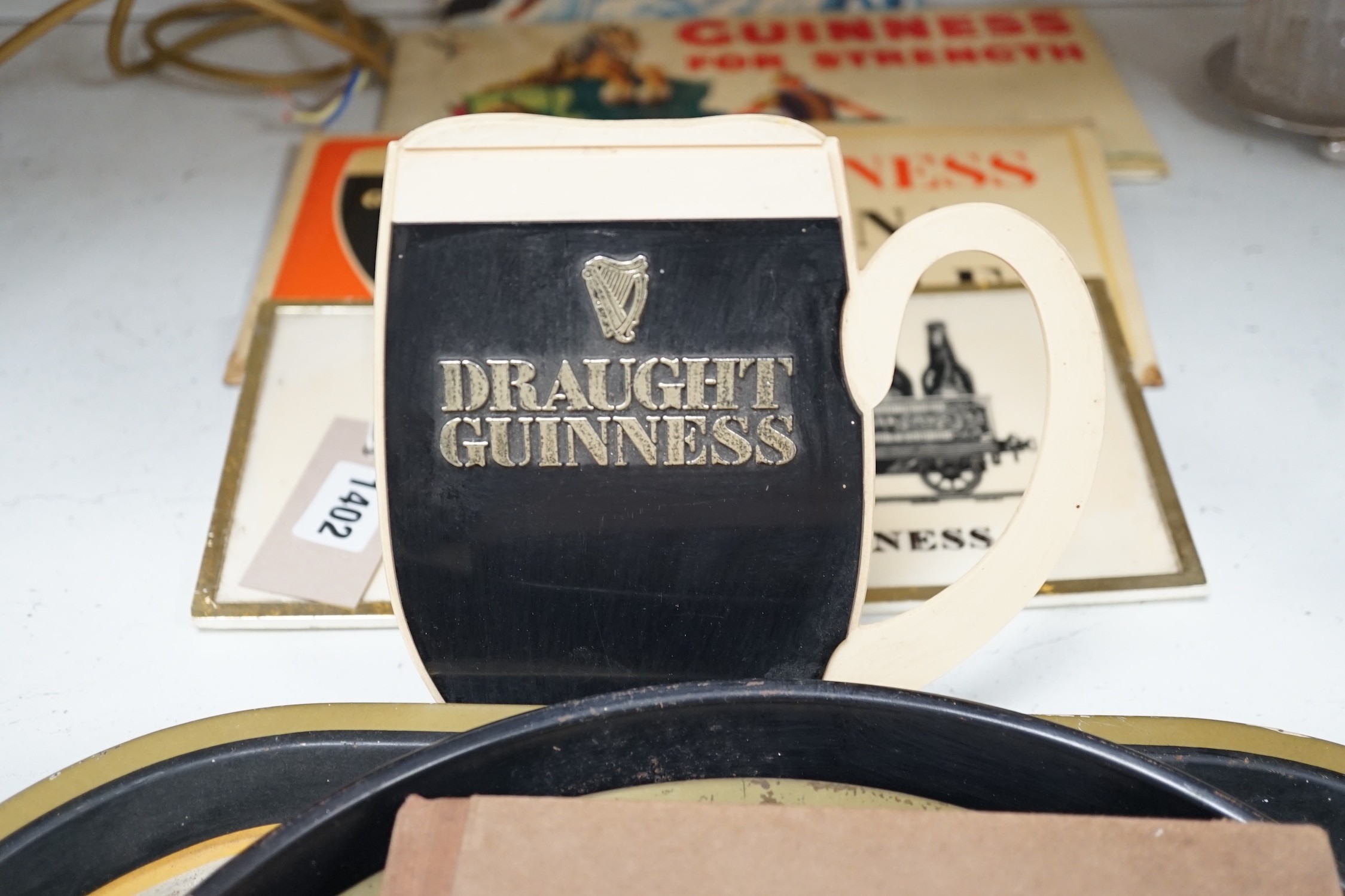 Five Guinness advertising signs, mirror, trays and a book - St. James’s Gate Brewery History and - Image 2 of 5