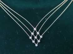 A boxed modern 18ct gold and nine stone diamond chip set triple fine strand necklet, approx. 42cm,