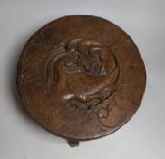 A South East Asian circular carved wooden stool, 36cms diameter