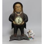 An American cast iron novelty 'John Bull' timepiece and a porcelain group