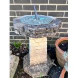 An octagonal reconstituted stone sundial on brick effect pillar, height 75cm *Please note the sale