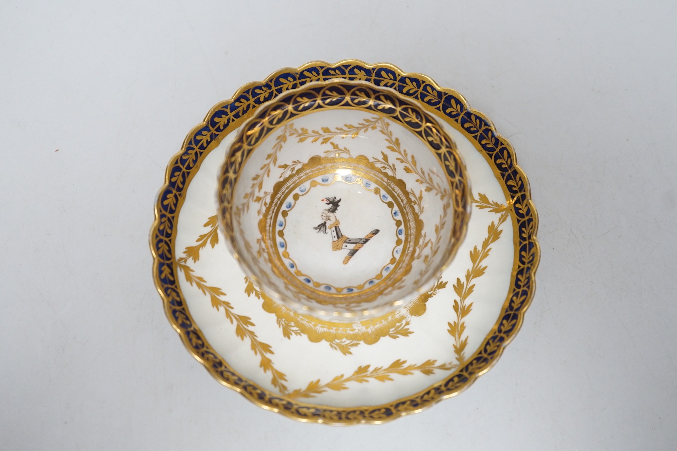 An 18th century Caughley rare teabowl and saucer painted with a crest of an arm clutching a dragon - Image 2 of 2