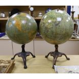 A Cartocraft USA globe on stand and another similar globe on stand, tallest 52cms high