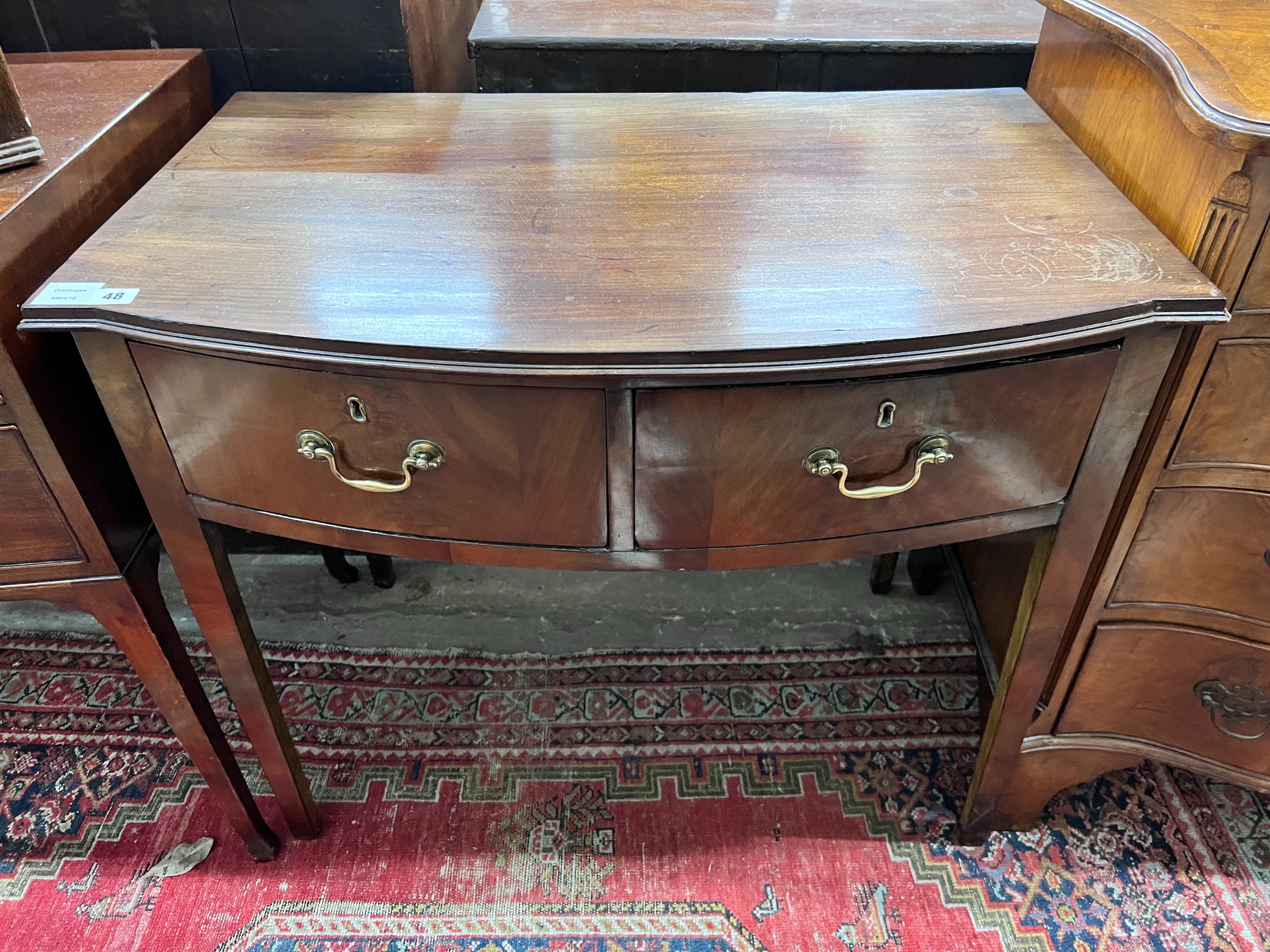 A George III mahogany bowfront two drawer side table, width 86cm, depth 54cm, height 74cm *Please