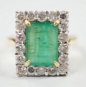 A modern 18ct gold, emerald and diamond set rectangular cluster ring, size Q, gross weight 6.4