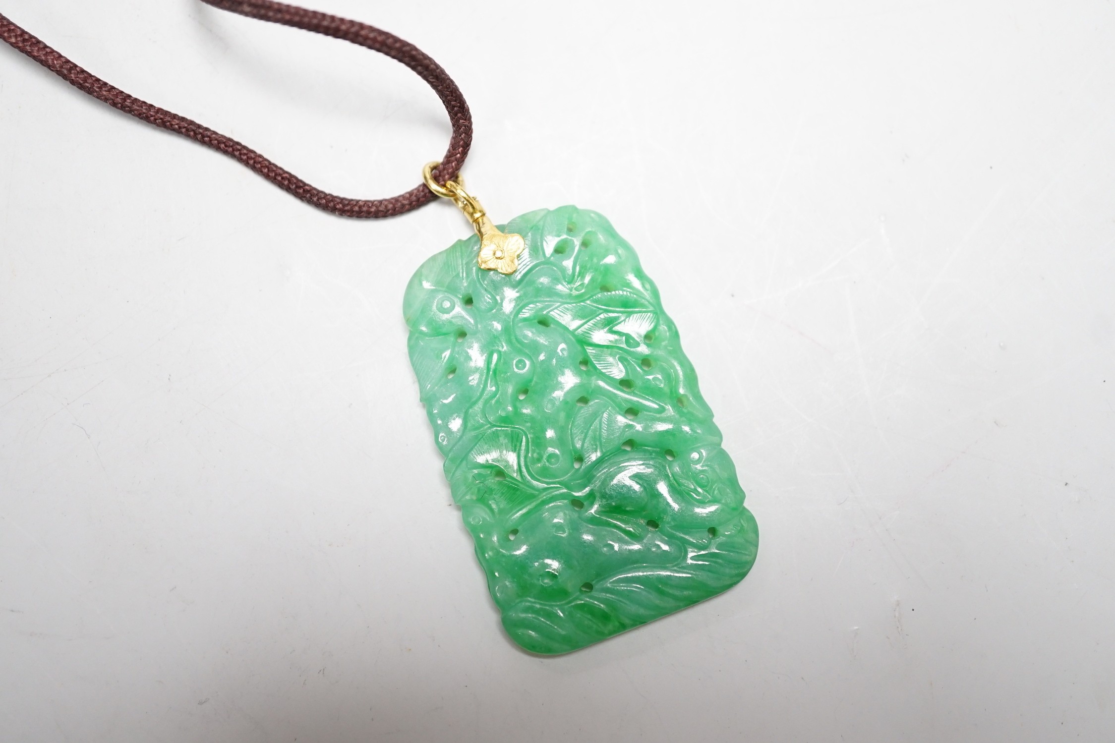 A carved Chinese jadeite pendant with pierced decoration. 5.5 x 3cm - Image 2 of 2