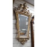 A late 19th century Continental giltwood cartouche shaped wall mirror, width 54cm, height 100cm *