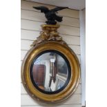 A Regency ebonised and giltwood convex wall mirror, height 87cm *Please note the sale commences at