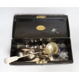 A tin box containing silver plated cutlery and cruets etc