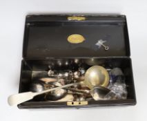 A tin box containing silver plated cutlery and cruets etc