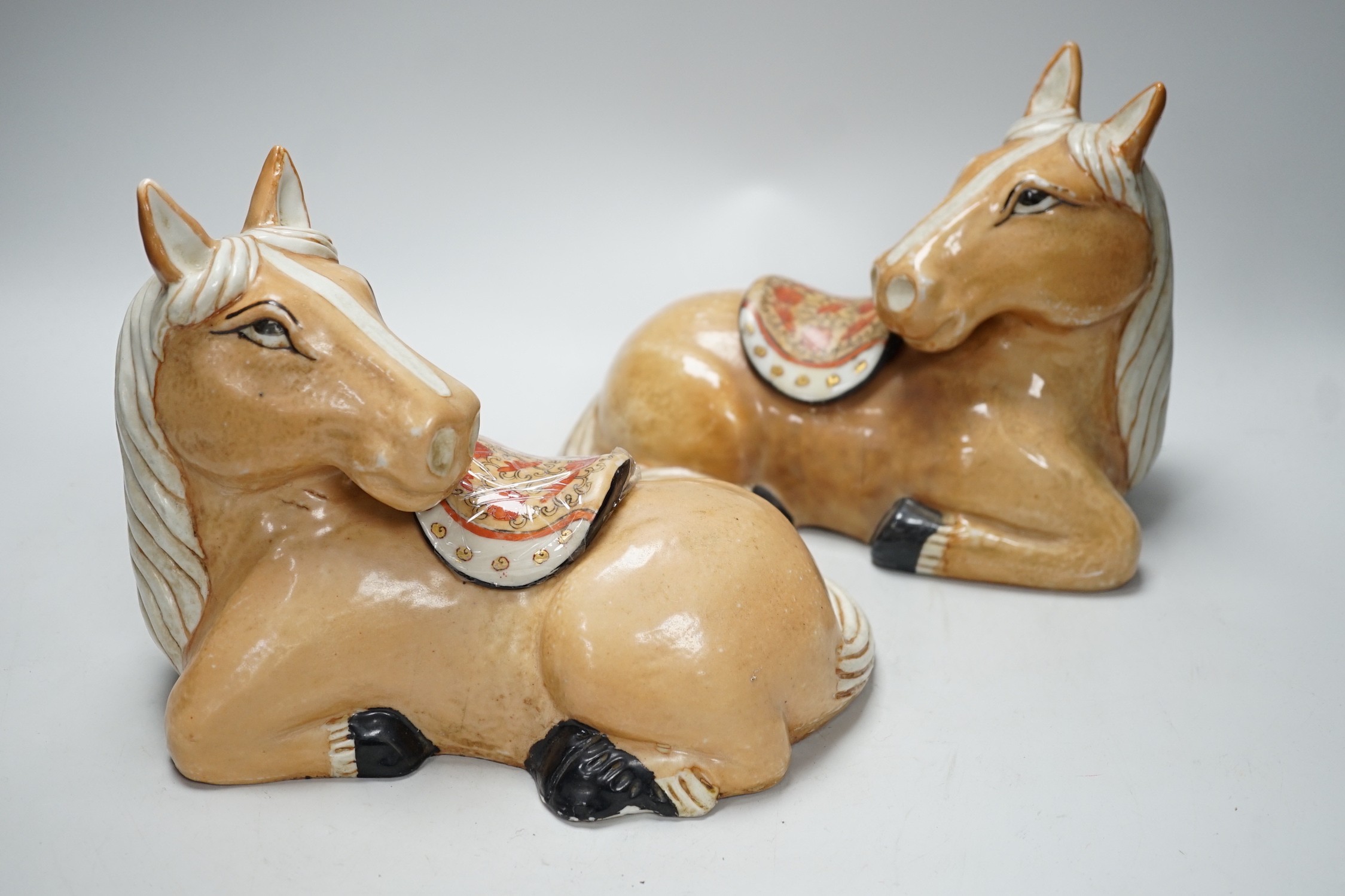 A pair of Chinese ceramic seated horses, 18cm high