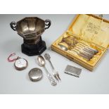 A late Victorian silver vesta case, a silver pill box, a small silver trophy cup, a cased set of six