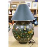 An Indian spherical green ground papier mache table lamp, decorated with hunting scenes and green